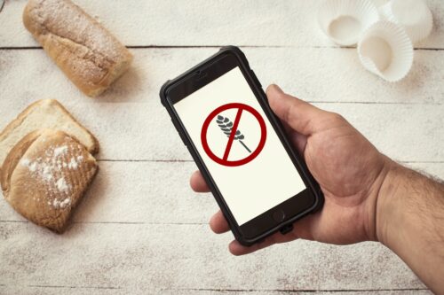 Gluten free concept. Hand holding a mobile phone